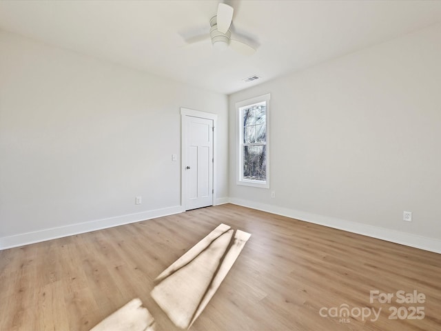 empty room featuring ceiling fan and light hardwood / wood-style floors