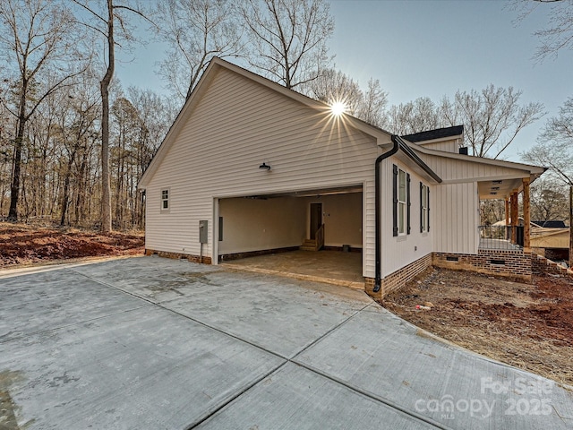 view of home's exterior featuring a garage and covered porch