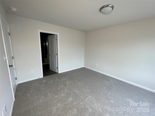 unfurnished bedroom featuring dark colored carpet