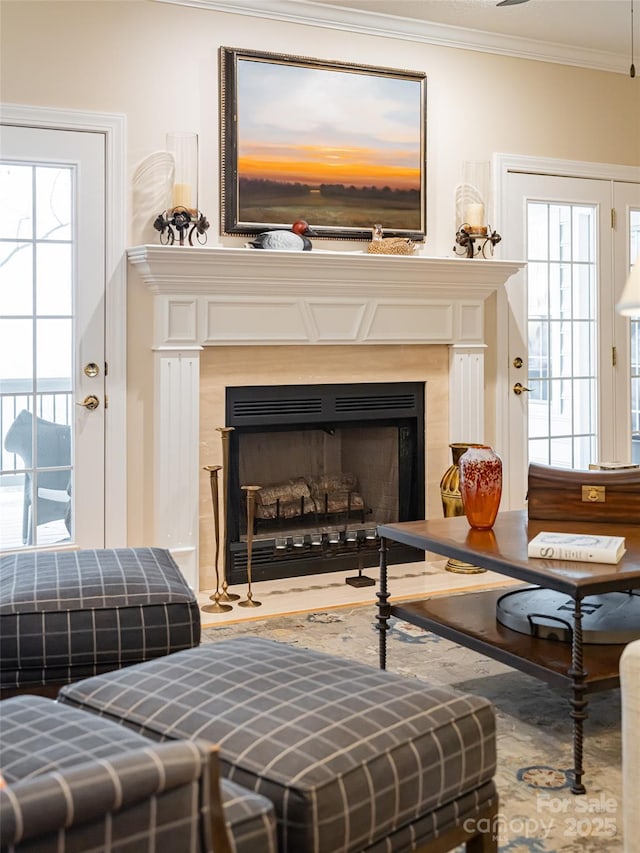 sitting room featuring a high end fireplace and ornamental molding