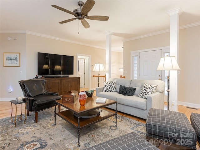 living room featuring crown molding, ceiling fan, and light hardwood / wood-style floors