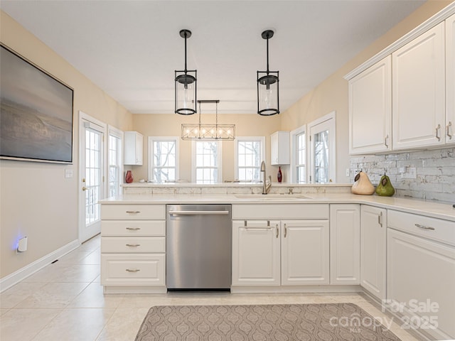 kitchen with white cabinetry, dishwasher, sink, decorative light fixtures, and light tile patterned floors