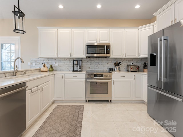 kitchen featuring white cabinets, premium appliances, and sink