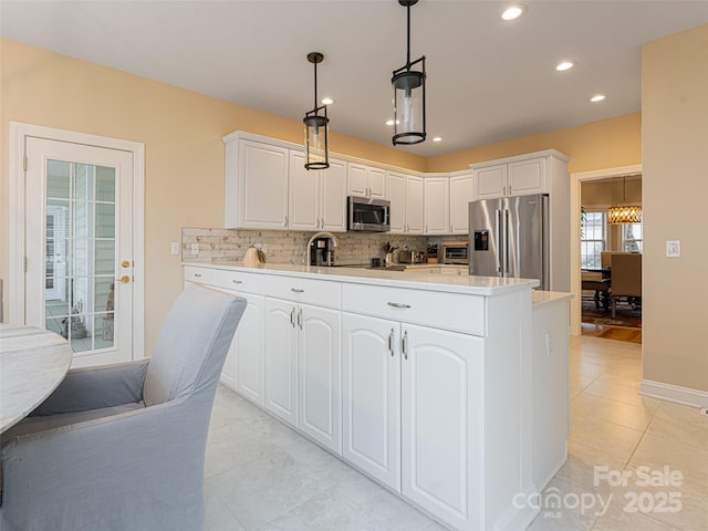 kitchen featuring hanging light fixtures, tasteful backsplash, light tile patterned flooring, white cabinetry, and stainless steel appliances