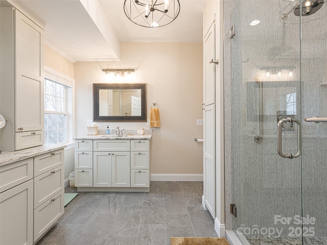 bathroom with a notable chandelier, vanity, and an enclosed shower