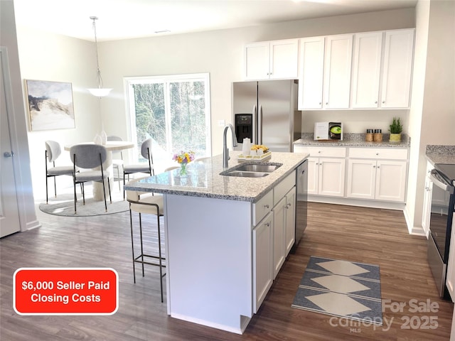 kitchen featuring white cabinetry, sink, and pendant lighting