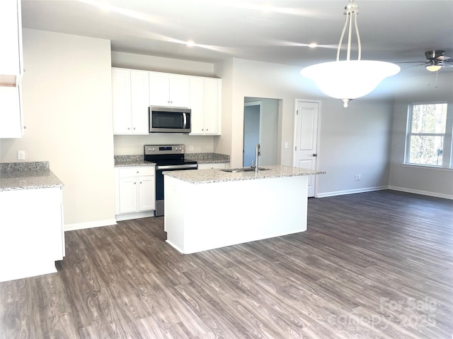 kitchen featuring appliances with stainless steel finishes, sink, pendant lighting, white cabinetry, and an island with sink