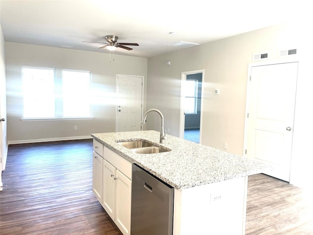 kitchen featuring ceiling fan, sink, dishwasher, white cabinetry, and an island with sink