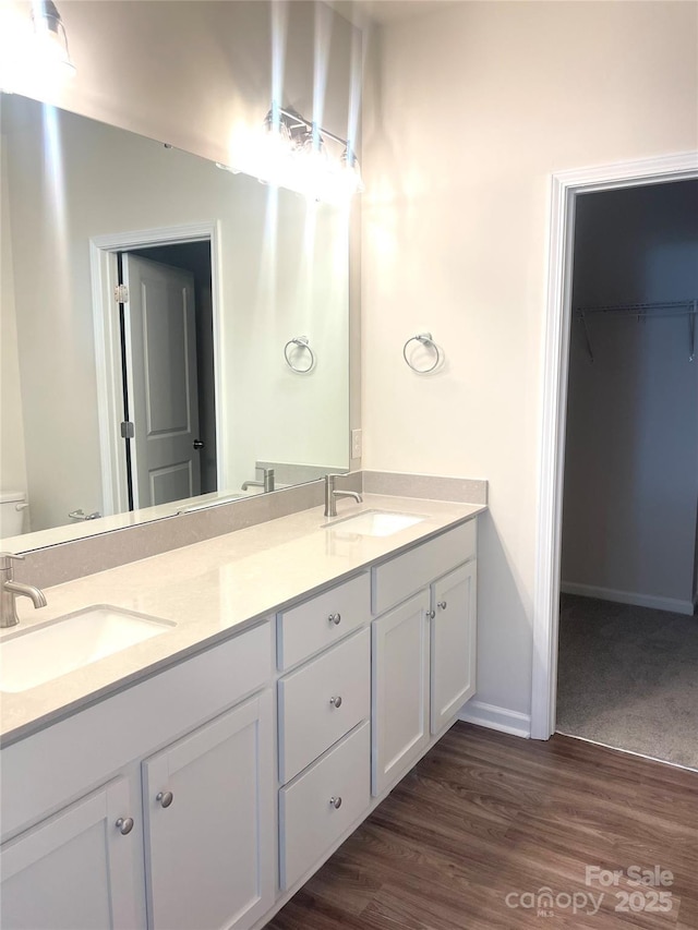 bathroom with hardwood / wood-style floors, vanity, and toilet