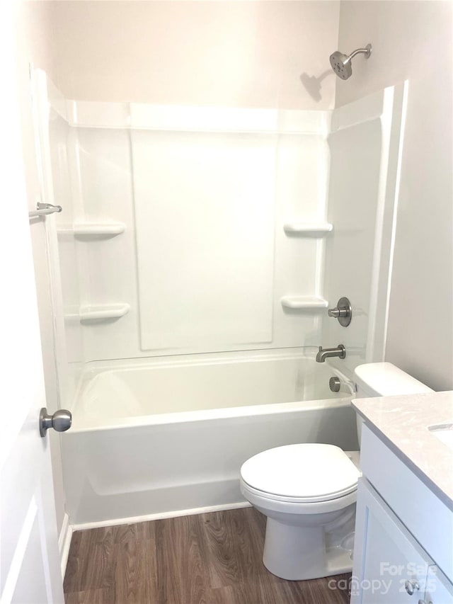 full bathroom featuring hardwood / wood-style floors, vanity, toilet, and shower / tub combination