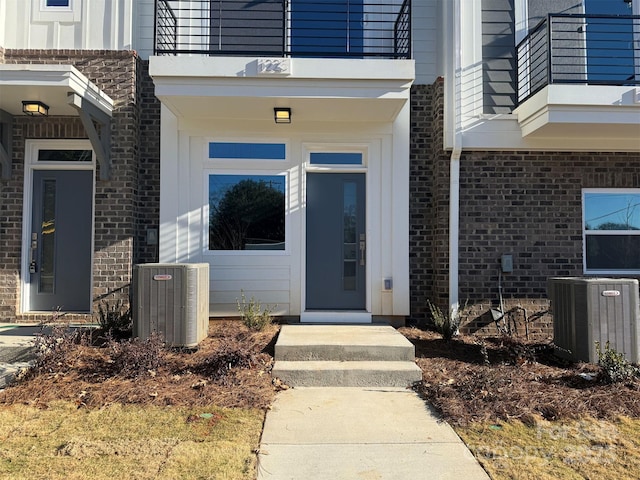 property entrance featuring a balcony and central AC