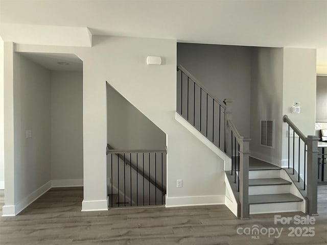 stairs featuring hardwood / wood-style flooring