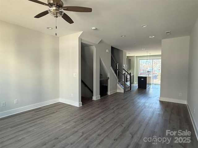 empty room with ceiling fan and dark wood-type flooring