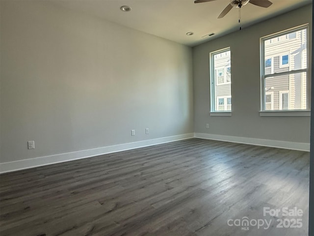 unfurnished room with ceiling fan and dark hardwood / wood-style flooring