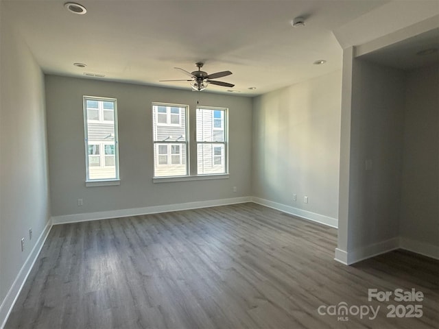 spare room featuring hardwood / wood-style floors and ceiling fan