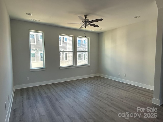 spare room featuring hardwood / wood-style floors and ceiling fan