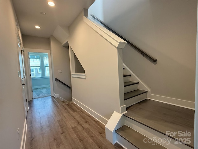 stairs featuring hardwood / wood-style flooring