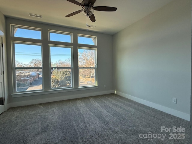 spare room featuring ceiling fan and carpet floors