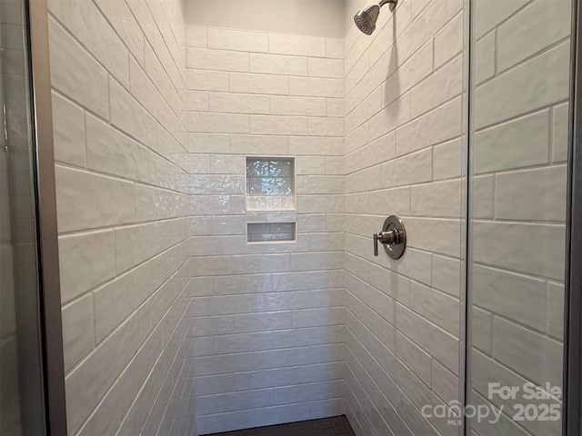 bathroom with tiled shower