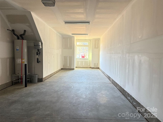 garage with a garage door opener and water heater