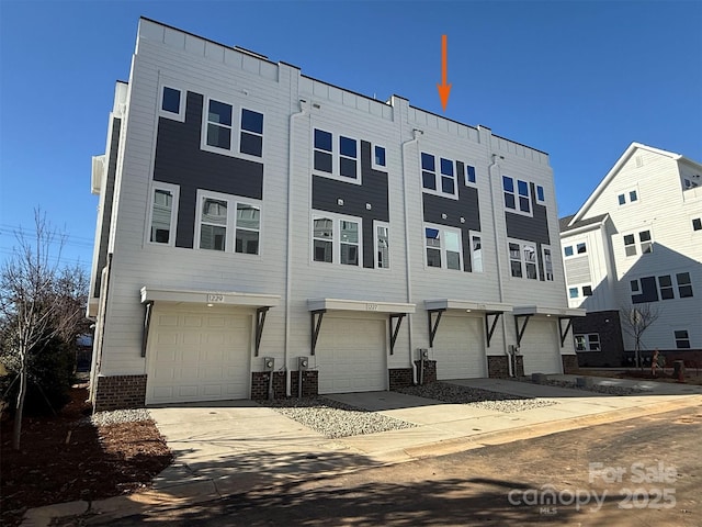 rear view of property featuring a garage