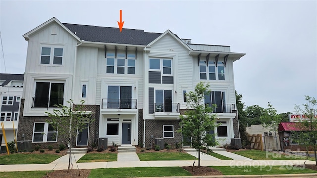 1225 E 34th St Unit Csw0419, Charlotte, NC 28205 - view of front of property featuring a balcony, fence, central AC, and board and batten siding