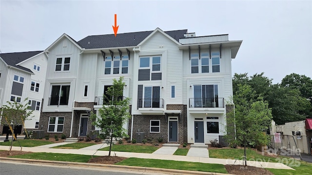 1225 E 34th St Unit Csw0419, Charlotte, NC 28205 - view of front of property with board and batten siding, cooling unit, brick siding, and a balcony