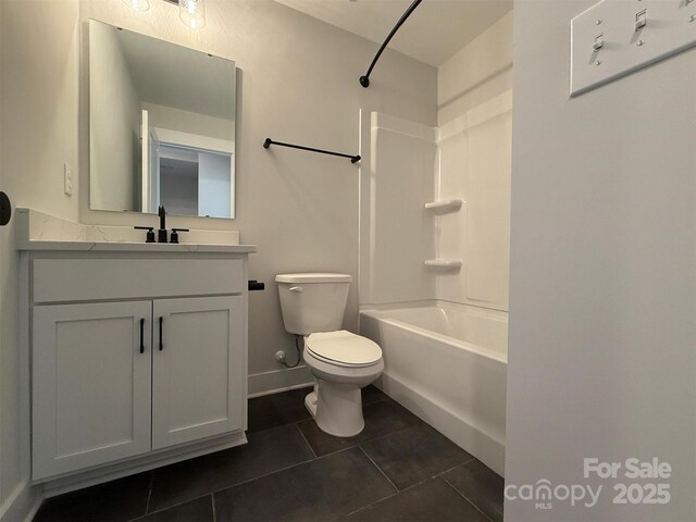 full bathroom with vanity, baseboards, tub / shower combination, tile patterned floors, and toilet