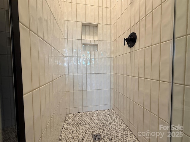 bathroom with tiled shower