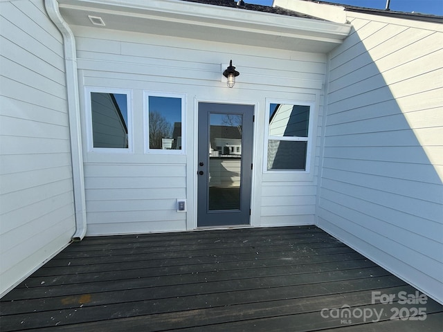 doorway to property featuring a deck and visible vents