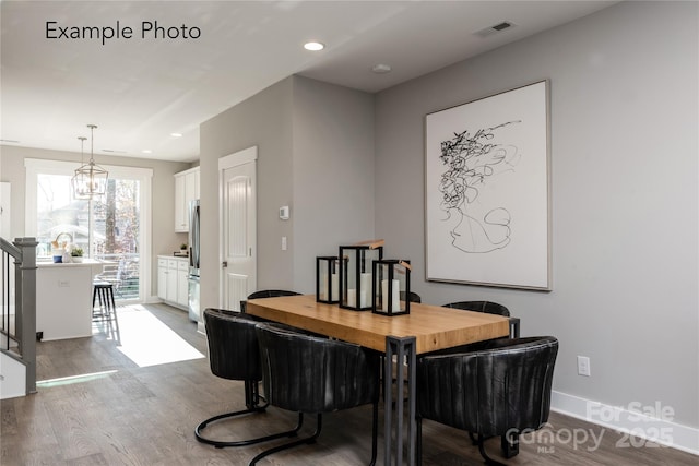 dining area with wood finished floors, visible vents, baseboards, recessed lighting, and stairs