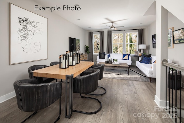 dining room with a ceiling fan, wood finished floors, and baseboards