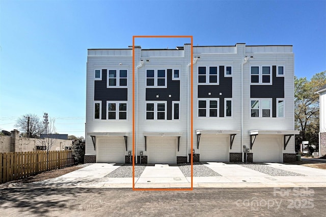 1227 E 34th St Unit Csw0420, Charlotte, NC 28205 - rear view of house featuring a garage, fence, and brick siding