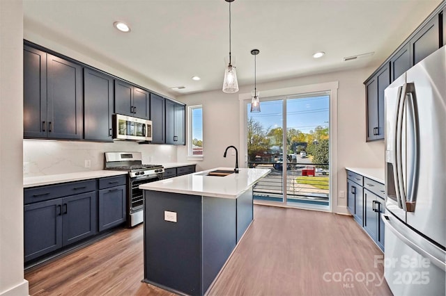 1227 E 34th St Unit Csw0420, Charlotte, NC 28205 - kitchen featuring stainless steel appliances, a sink, light wood-type flooring, recessed lighting, and a kitchen island with sink