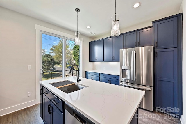 1227 E 34th St Unit Csw0420, Charlotte, NC 28205 - kitchen with appliances with stainless steel finishes, a sink, dark wood-type flooring, light stone countertops, and pendant lighting