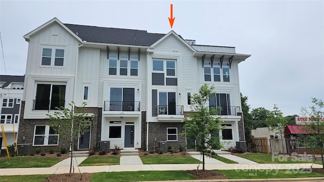 1227 E 34th St Unit Csw0420, Charlotte, NC 28205 - view of front of home with a balcony, fence, central AC unit, and board and batten siding