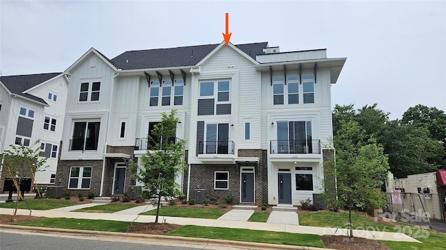1227 E 34th St Unit Csw0420, Charlotte, NC 28205 - view of front facade featuring board and batten siding, cooling unit, brick siding, and a balcony