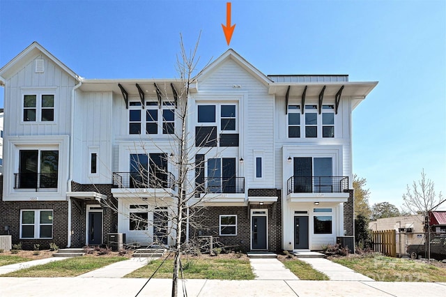 1227 E 34th St Unit Csw0420, Charlotte, NC 28205 - view of property featuring board and batten siding, brick siding, central air condition unit, and fence