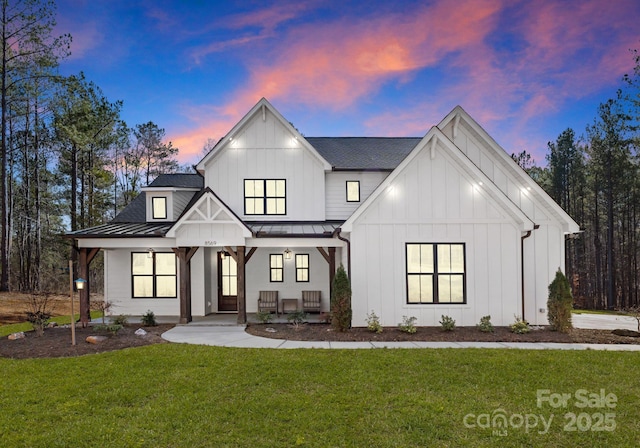 modern farmhouse featuring a lawn and covered porch