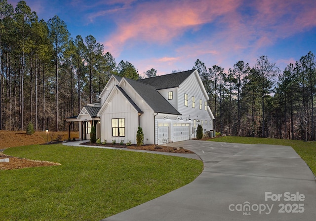 view of front of property featuring a garage and a lawn