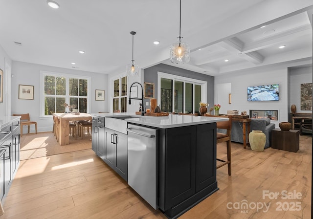 kitchen featuring coffered ceiling, beamed ceiling, a center island with sink, stainless steel dishwasher, and pendant lighting