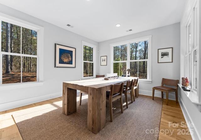 dining space with hardwood / wood-style floors