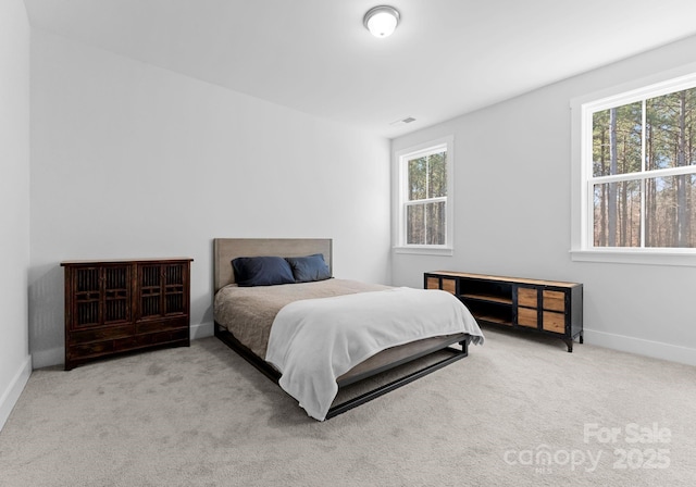 bedroom featuring light carpet