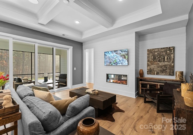 living room featuring light hardwood / wood-style flooring, a fireplace, coffered ceiling, and beamed ceiling