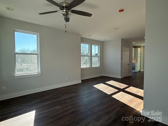 empty room with dark hardwood / wood-style floors and ceiling fan