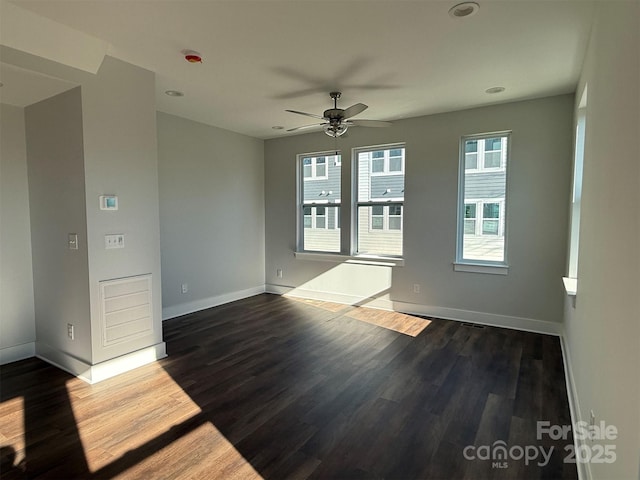 unfurnished room featuring ceiling fan and dark hardwood / wood-style flooring