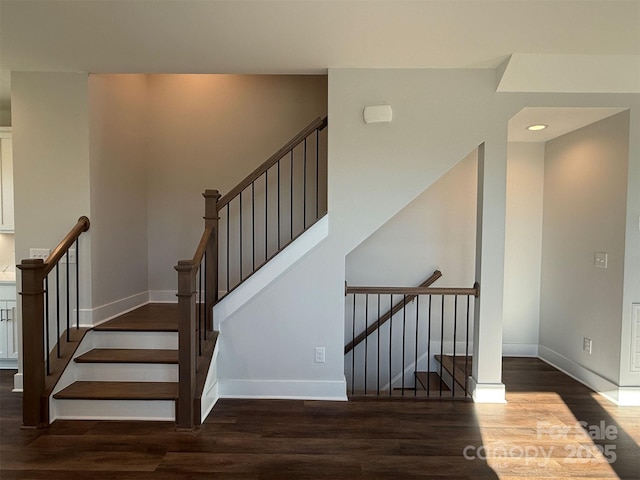 stairs featuring hardwood / wood-style flooring