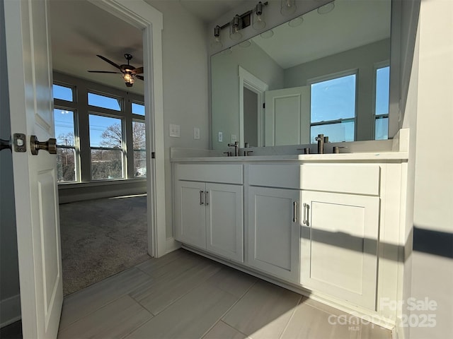 bathroom featuring tile patterned floors, ceiling fan, and vanity