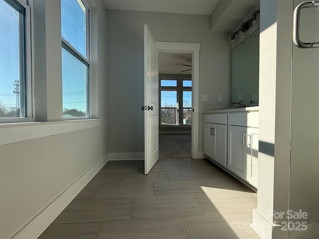 bathroom featuring tile patterned flooring, vanity, a wealth of natural light, and ceiling fan