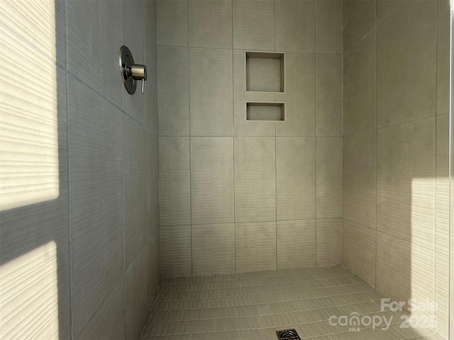 bathroom with tiled shower